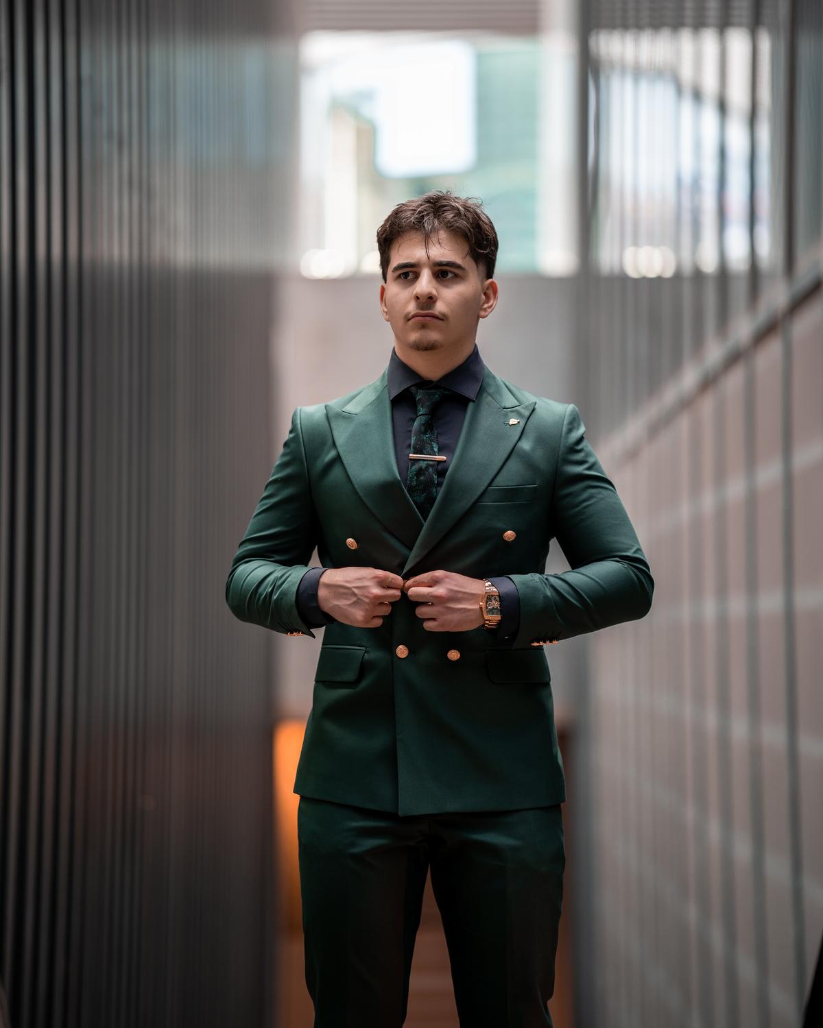 Mohsen Carter, founder of Unbreakable Ascent, in a green double-breasted suit